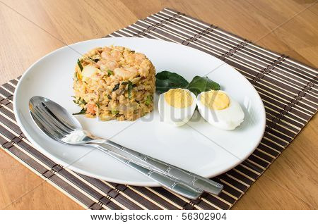 Khow Pat Tom Yum Koong - Stir fried spicy rice with herbs and prawns serving with boiled egg thai fo