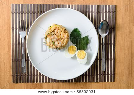 Khow Pat Tom Yum Koong - Stir fried spicy rice with herbs and prawns serving with boiled egg thai fo