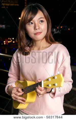 Pretty Asian Woman With Ukelele