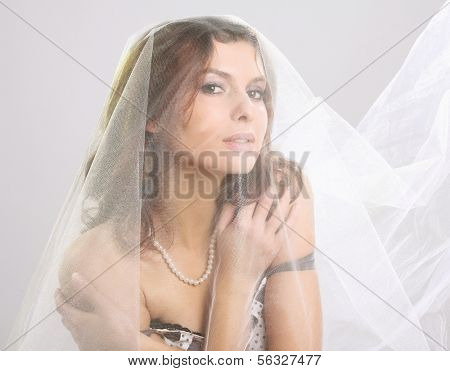 A fashionable woman standing with white material