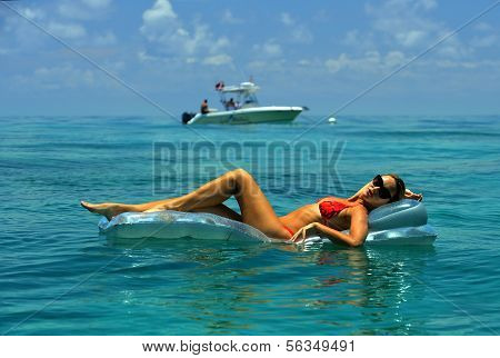 Woman in red bikini on floating device