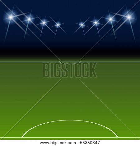 Green soccer field, bright spotlights