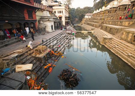 KATHMANDU, NEPAL - DEC 20: During the cremation ceremony along the holy Bagmati River in Bhasmeshvar Ghat at Pashupatinath temple, Dec 20, 2013 in Kathmandu, Nepal.
