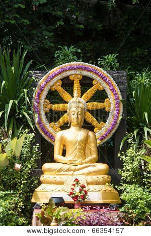 Ancient golden Buddha statue with wheel of life