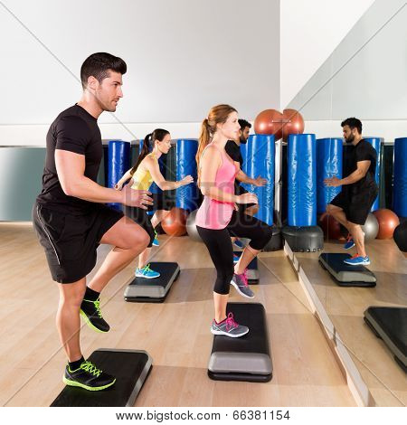 Cardio step dance people group at fitness gym training workout