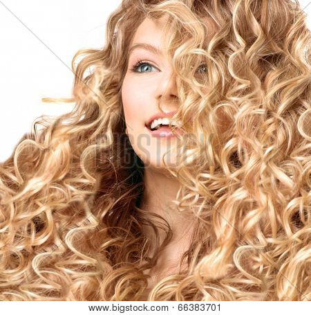 Beauty girl with blonde curly hair. Healthy and long permed Blond Wavy hair. Beautiful smiling young woman portrait. Beautiful face, natural make up