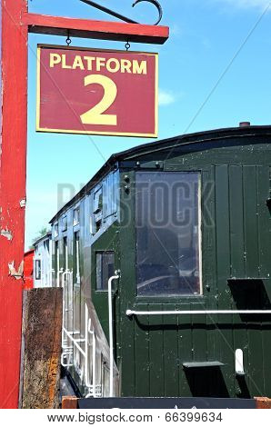 Platform sign and railway wagon.