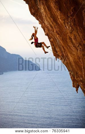Female rock climber falling of a cliff