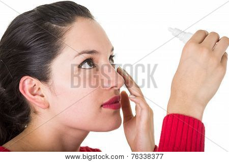 beautiful young woman holding eye drop bottle