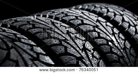  winter car tyre on a black background