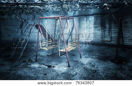 Old rusted playground, abandoned aged swings, destroyed childhood, damages in attraction park, war and poverty concept