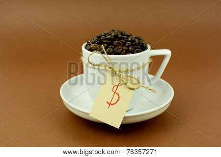 Photo of Coffee cup and saucer with a bow coffee beans and dollar sign