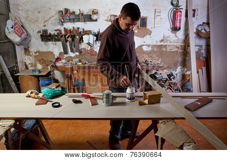 Carpenter Apply Glue On Wooden Piece