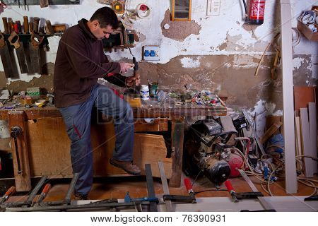 Carpenter Carving An Assembly Hole