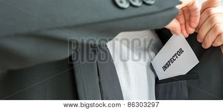 Inspector Removing A White Card With Inspector Sign From The Inner Pocket Of His Jacket