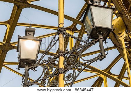 Decorative lamps hanging from old bridge