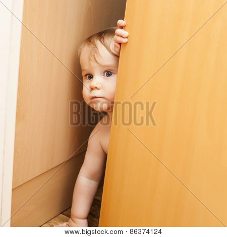 Curious Cute Baby Boy Looking Through Ajar Door