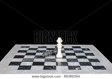 The winner. King beats the king, chess play on a marble chess board