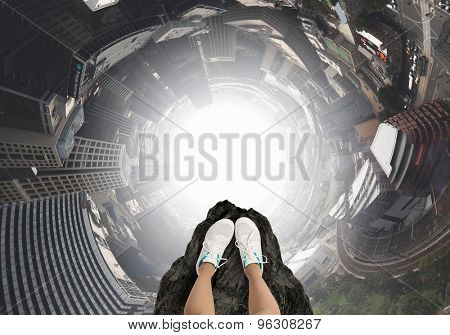 Close up of woman legs standing on the edge of rock