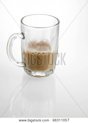 Half glass of Tea with milk or Teh Tarik in Malaysia