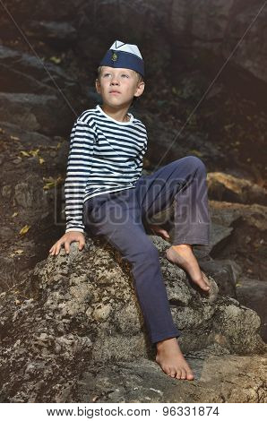 The boy in the vest and the marine cap