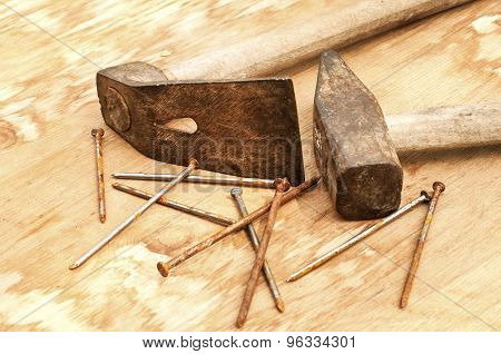 Old hammer, adze and rusty nails