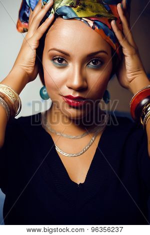 beauty bright african woman with creative make up, shawl on head like cubian