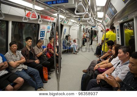 SINGAPORE - CIRCA FEBRUARY, 2015: Passengers in the train MRT. Singapore subway, also known as MRT, started operating in 1987. It is network length is 130 kms, it has 87 stations and 4 lines.