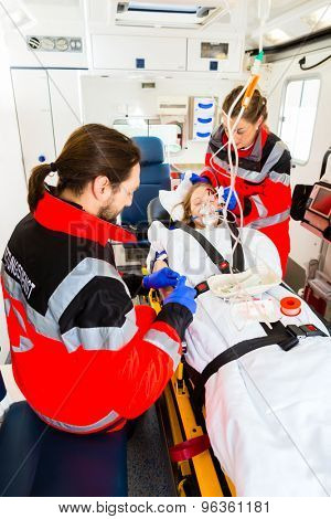 Emergency doctor and nurse or ambulance team medicate accident victim 