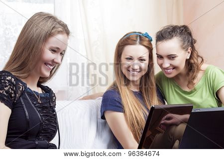 Modern Lifesrtyle Concept. Portrait Of Three Young Happy Laughing Caucasian Girlfriends With Laptops