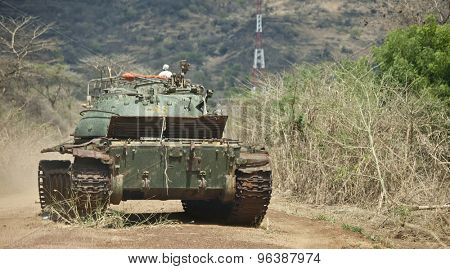 TORIT, SOUTH SUDAN-FEBRUARY 23, 2013: A wrecked tank stands in the road between Juba and Torit, a relick of civil war.