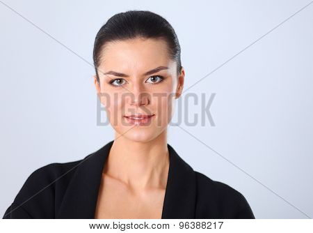 A young woman standing, isolated on graybackground