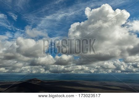 Beautiful cumulus clouds over the fields of scoria. North Breakthrough Great Tolbachik Fissure Eruption 1975