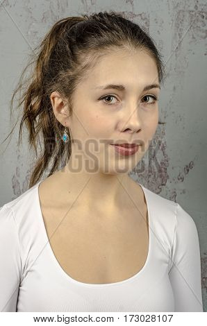 Portrait of a young romantic girl with curly hair and a white blouse
