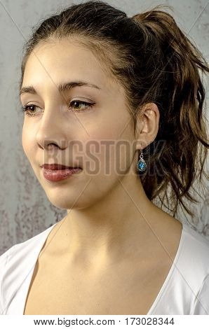 Portrait of a young romantic girl with curly hair and a white blouse