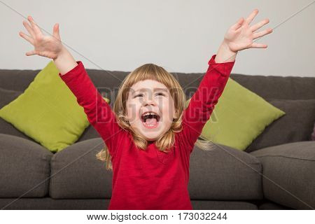 Funny Child With Hands Up And Happy Shouting