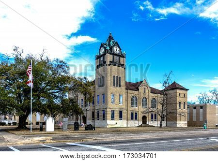 Prattville Alabama USA - January 28 2017: Landscape view of the Autauga County Courthouse with partly cloudy sky.
