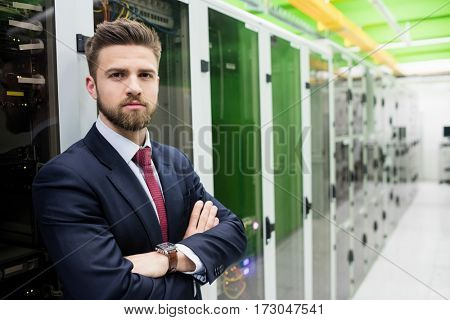 Portrait of technician standing with arms crossed in a server room