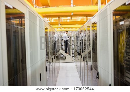 Technician using digital cable analyzer in server room