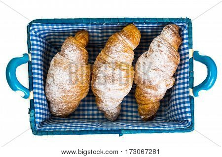 Delicious crispy croissants in bread basket. Studio Photo