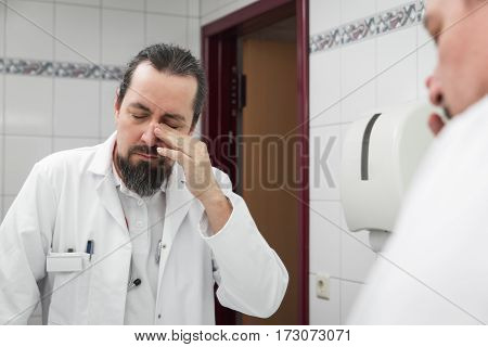 Male Doctor Looks Tired