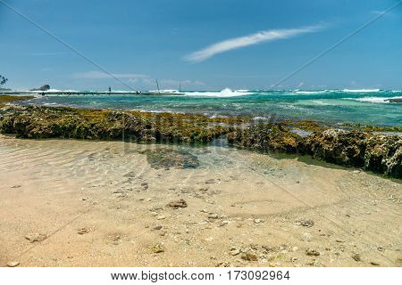 Sunny beach near Koggala - Sri Lanka The area famous for its distinct stilt fishermen, who erect a single pole in the chest-deep water on the beach, just few meters off-shore. Splittoned, vivid image.