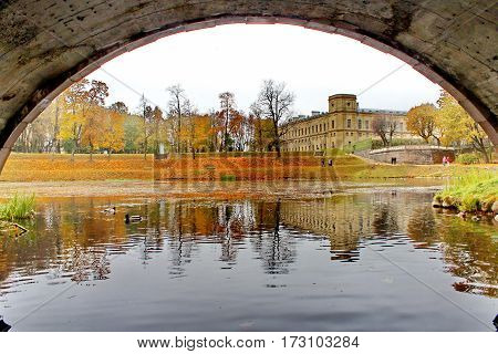 Beautiful romantic alley in a park with colorful trees and sunlight. autumn natural background Gatchina