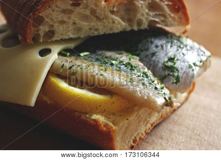 Herring sandwich with lemon and cheese and spices