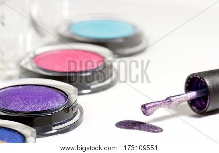 Beautiful bright eye shadows with nail brush isolated on white background