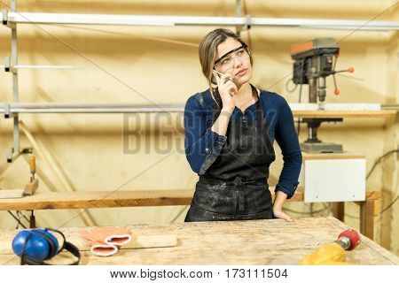 Female Carpenter In A Phone Call