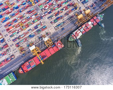 container ship in import export and business logistic.By crane Trade Port Shipping.cargo to harbor.Aerial view.Water transport.International.Shell Marine.Top view.