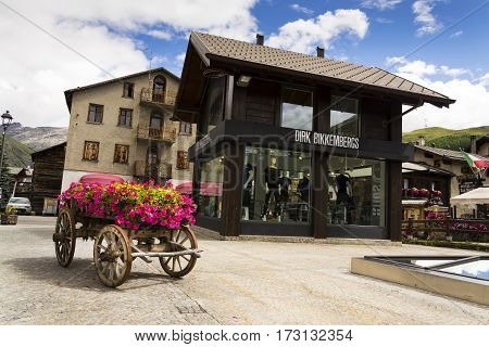 Livigno, Italy - August 1: Wain With Flowers In Front Of Fashion Shops On Streets Of Duty-free Area