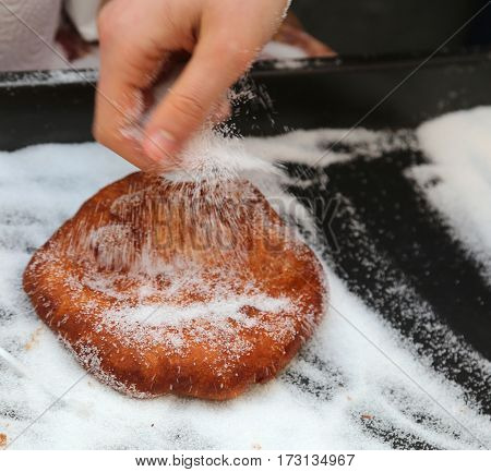 Hand Of The Young Girl Puts Sugar Over The Pancake In The Food S