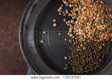 Placer lentils on a pewter plate on the table horizontal